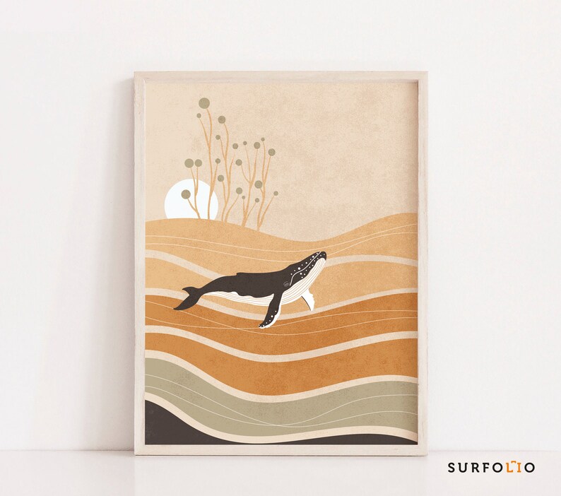 May include: A framed art print featuring a stylized illustration of a whale swimming above layered, abstract waves. The color palette includes shades of brown, beige, and gray. The whale is dark with white accents. The artwork has a minimalist, nature-inspired theme.
