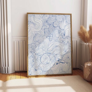 May include: A framed print with a white background and blue abstract swirls. The text "The world is your oyster" is written in blue in the bottom right corner.