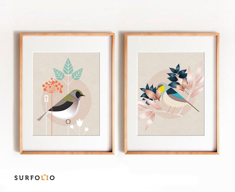 May include: Two framed prints with a minimalist design featuring birds and foliage. The print on the left features a green and white bird with a red berry branch. The print on the right features a blue and yellow bird with pink and blue foliage.
