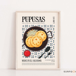 May include: A framed poster featuring a graphic illustration of pupusas, a Salvadoran dish. The image shows three golden-brown pupusas on a black plate, with a side of coleslaw and a small bowl of red sauce. Text includes "PUPUSAS" and "MADE IN EL SALVADOR."