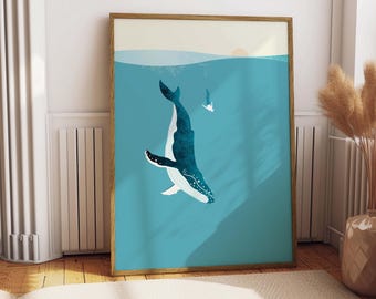 May include: A vertical rectangular wall art print in a wooden frame featuring a deep blue whale swimming in turquoise water. A small white figure of a person swims near the surface under a pale sun. The artwork uses flat colors and simple shapes.