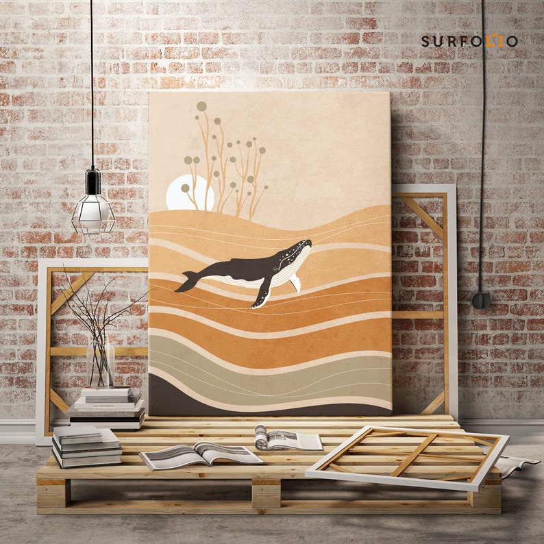 May include: Canvas art print featuring a stylized illustration of a whale swimming in an ocean scene. The artwork uses a palette of warm earth tones and depicts a sun and abstract plants. The print is displayed on a wooden pallet.