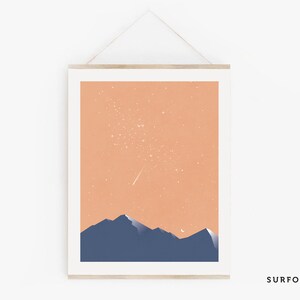 Pode incluir: Uma impress&atilde;o de arte digital que apresenta uma paisagem minimalista com um c&eacute;u cor de p&ecirc;ssego, uma estrela cadente e uma lua crescente sobre uma cordilheira azul escura.
