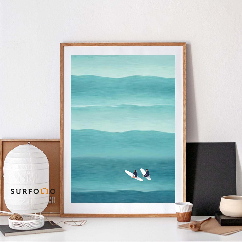 May include: A framed illustration of two people on surfboards in a turquoise ocean with white waves. The ocean is painted with horizontal brushstrokes.