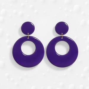 May include: A white ceramic mug with a black handle and the text "But First, Coffee" in a handwritten style. The mug is on a white surface. The mug is 4 inches tall.