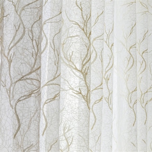 May include: White sheer curtains with a delicate brown branch pattern. The curtains are translucent and allow light to filter through.