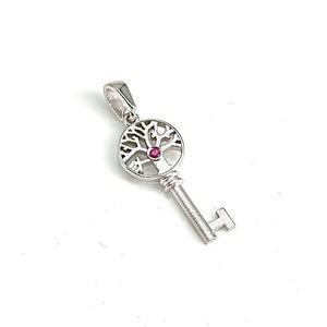 May include: Silver key pendant with a tree of life design and a pink gemstone in the center.