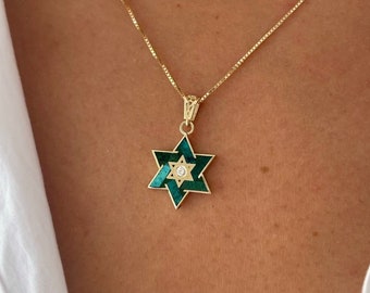 May include: A gold chain necklace with a green and gold Star of David pendant featuring a small diamond in the center.