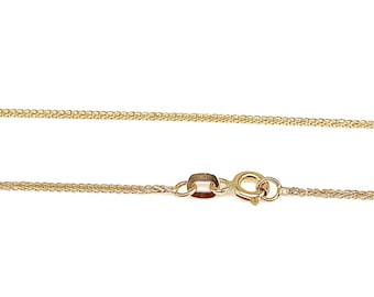 May include: A gold chain necklace with a lobster clasp closure.
