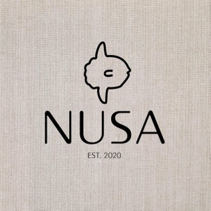 May include: A logo featuring a black outline of a sunfish above the word "NUSA" in a bold, sans-serif font. Below the word "NUSA" is the text "EST. 2020". The background is a textured, off-white fabric.