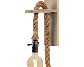 May include: A rustic wall sconce with a natural rope cord and a black metal socket. The sconce is made of wood and has a simple design.