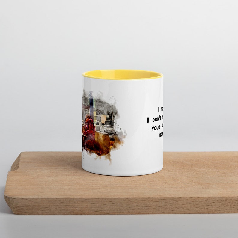 May include: White ceramic mug with a yellow rim. The mug features a watercolor-style image of a person sitting at a table with the text "I don't need your kind of love, but I'll take your money."
