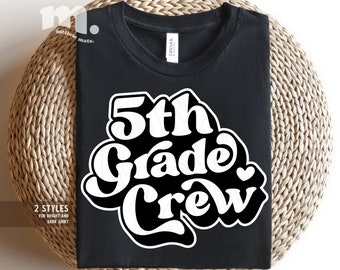 May include: Black t-shirt with white text that says "5th Grade Crew" in a retro font style. A small white heart is next to the word "Crew".