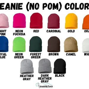 May include: A selection of beanies in a range of colours: light pink, neon fuchsia, red, cardinal, gold, and orange. Other colours include royal blue, neon green, forest green, brown, camel, white, heather grey, dark heather grey, and black. Text reads "BEANIE (NO POM) COLORS".