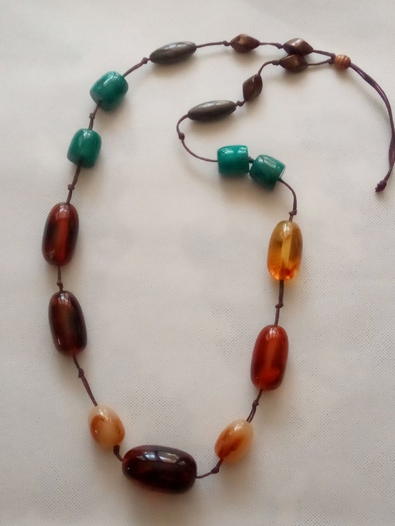 Old long individually knotted necklace with solid
