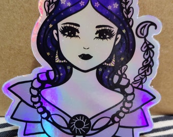 May include: A holographic sticker featuring a woman with a purple and blue crown of stars and a scorpion tail. The woman has dark eyes and a dark mouth. The sticker has a purple and blue iridescent background.