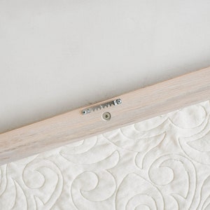 sawtooth installed on whitewash quilt hanger