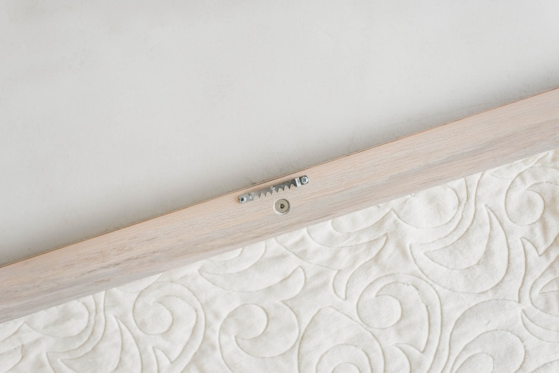 sawtooth installed on whitewash quilt hanger