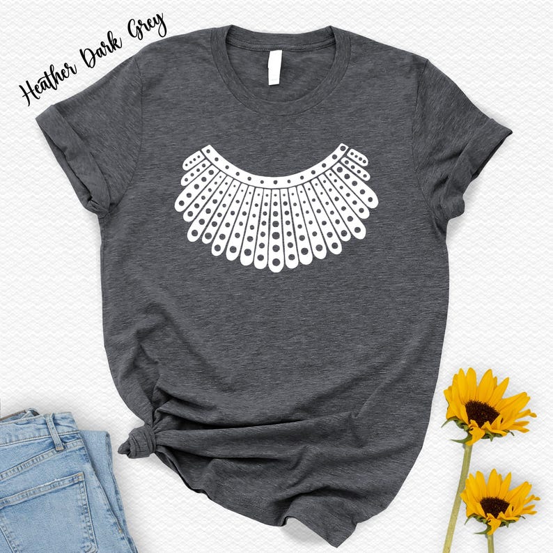 a gray t-shirt with a white graphic design, a pair of blue jeans, and two yellow sunflowers.