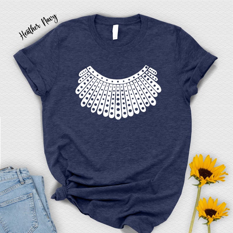 a navy blue t-shirt with a white graphic design, a pair of blue jeans, and two yellow sunflowers.