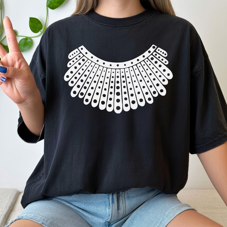 A person wearing a black t-shirt with a white design on it.