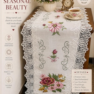 May include: A white linen table runner with hand-embroidered floral designs and a delicate lace edge. The runner features pink and red flowers, and the text "THE LINEN PETAL". Perfect for tables, dressers, and cabinets.