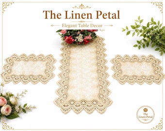 May include: Elegant table decor set featuring a cream-colored table runner and two matching placemats. The set is made of a delicate, lacy material with floral accents. The text "The Linen Petal" is displayed at the top.