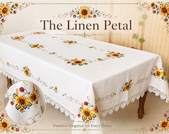 May include: White rectangular tablecloth with embroidered sunflowers and a lace trim. The text "The Linen Petal" is displayed at the top, with "Timeless Elegance for Every Home" at the bottom. The tablecloth is draped over a wooden table.