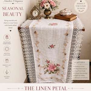 May include: A white linen table runner with embroidered pink roses and a delicate lace edge. The runner is displayed on a wooden table, with a floral arrangement and a decorative clock. The text reads "The Linen Petal".