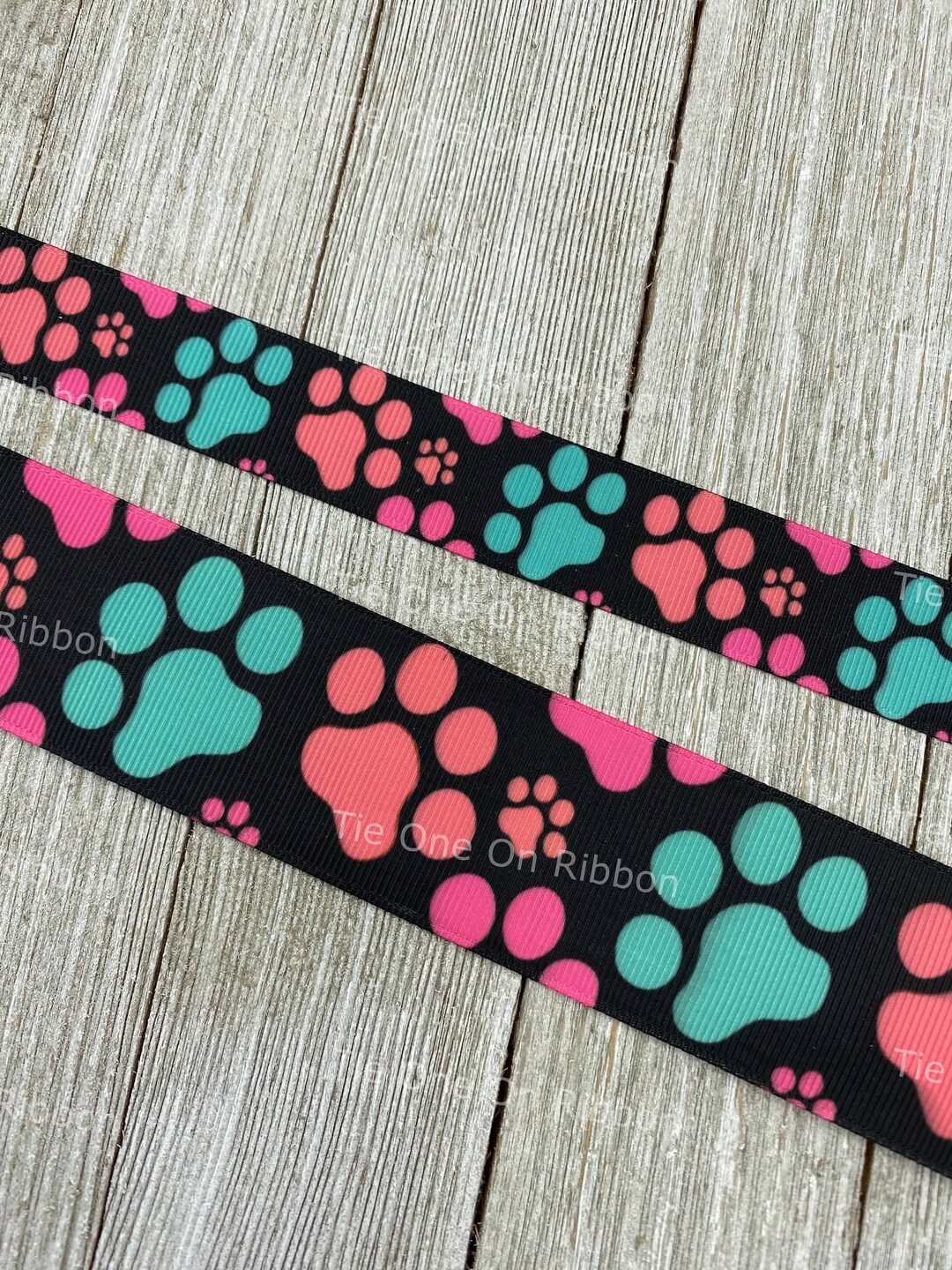 Peach, Pink and Blue Dog Paw Prints on Black Background Printed ...