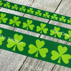 Shamrock ribbon with white clovers on a green and black buffalo plaid  background printed on 1.5 white grosgrain, 10 yards