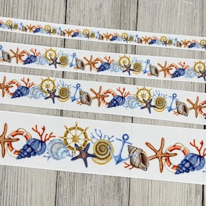 May include: White ribbon with a nautical design featuring seashells, starfish, anchors, and ship wheels in shades of blue, orange, and gold. The ribbon is perfect for crafting and adding a coastal touch to various projects.