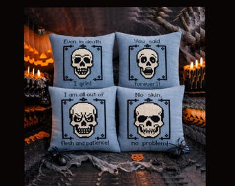 May include: Four square light blue pillows featuring black cross-stitched skull designs and text. The top left reads Even in death I grin, top right You said forever?!, bottom left I am all out of flesh and patience!, and bottom right No skin, no problem!