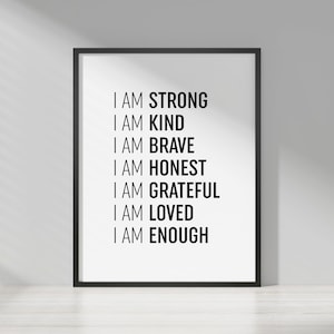 May include: Black and white framed print with the text "I AM STRONG, I AM KIND, I AM BRAVE, I AM HONEST, I AM GRATEFUL, I AM LOVED, I AM ENOUGH".