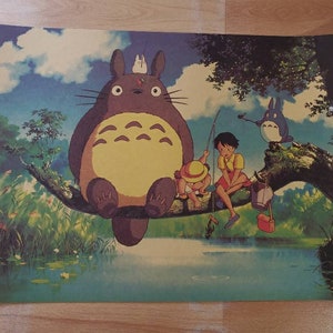 May include: A whimsical illustration of a large, furry, gray and yellow creature with big eyes, sitting on a tree branch with two children fishing in a pond. The creature is surrounded by lush green foliage and a blue sky with white clouds.