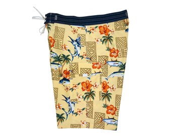 May include: Yellow swim trunks with a tropical print featuring palm trees, fish, and hibiscus flowers. The trunks have a dark blue waistband.