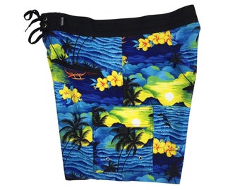 May include: Blue swim trunks with a tropical print featuring palm trees, flowers, and a sunset. The trunks have a black waistband and a drawstring.