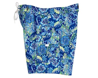 May include: Blue swim trunks with a floral pattern in shades of blue, green, and white.
