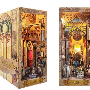 May include: A wooden 3D model of a dragon castle with a book cover that says "A Dance with Dragons". The castle is intricately detailed and features a throne room, a library, and a dragon skull.