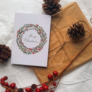 Cartolina di Natale con ghirlanda festiva, vuota all'interno, perfetta da inviare nel periodo natalizio alla famiglia