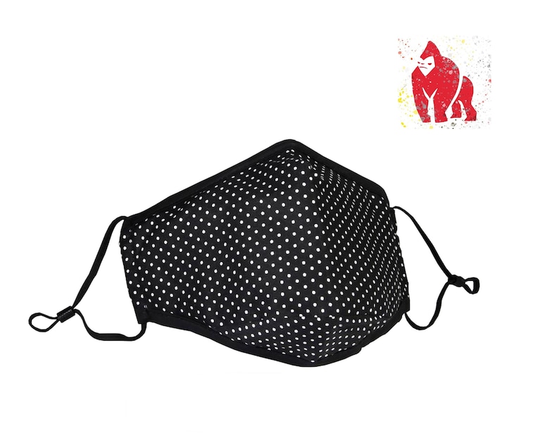 May include: Black face mask with white polka dots and adjustable ear loops.