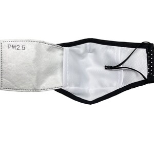 May include: A black face mask with white polka dots and a white filter insert labeled "PM2.5". The mask has an adjustable strap.