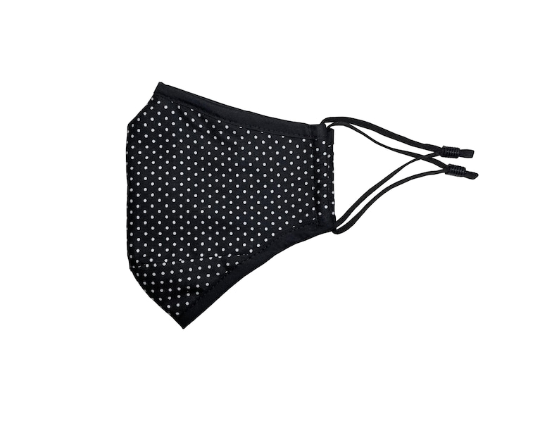 May include: Black face mask with white polka dots and adjustable ear loops.