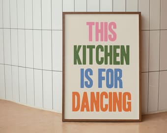 May include: A framed print with the text "THIS KITCHEN IS FOR DANCING" in colorful letters. The letters are pink, green, blue, and orange.