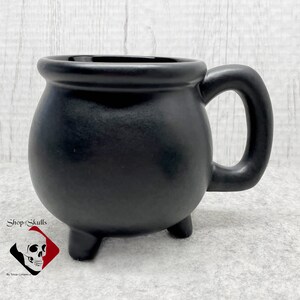 This cauldron mug can be paired with any of the creepy tea bag holders or snack plates I make, great to include in a gift basket.  Each mug is made to order and ships on completion. Shop for more amazing handmade items at www.ShopOfSkulls.com.