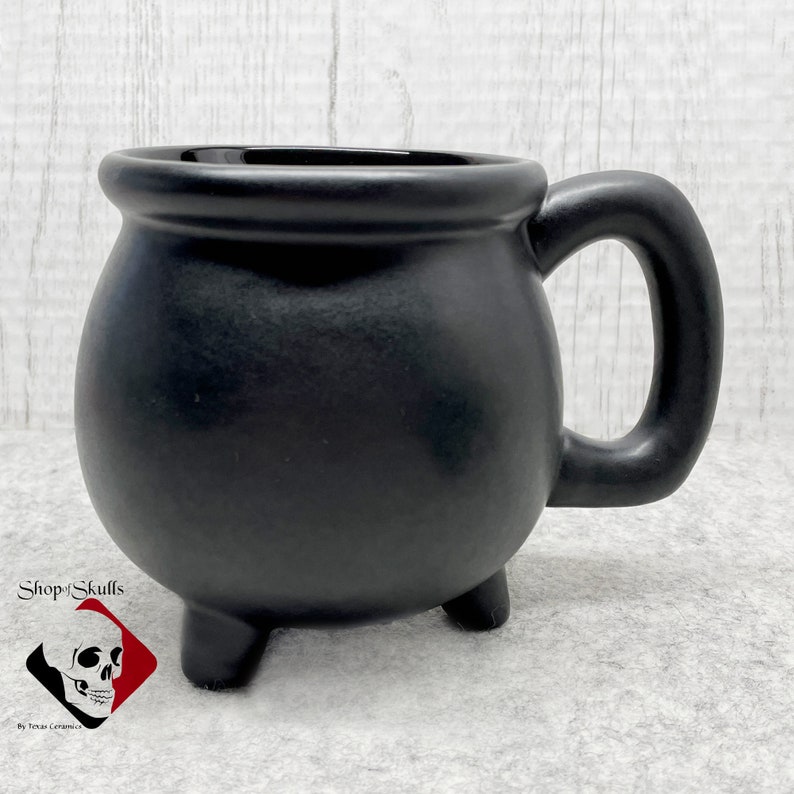 This cauldron mug can be paired with any of the creepy tea bag holders or snack plates I make, great to include in a gift basket.  Each mug is made to order and ships on completion. Shop for more amazing handmade items at www.ShopOfSkulls.com.