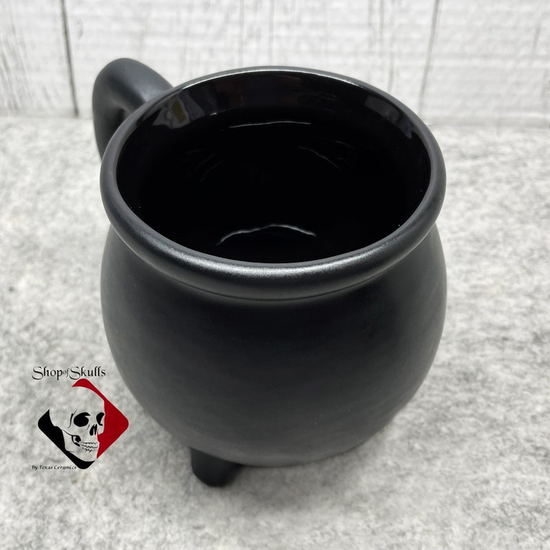 Black ceramic cauldron or kettle is made to be used for either hot or cold beverages, the entire mug is glazed in lead free glaze giving it a totally macabre or look. Dishwasher safe.
Shop for more amazing items on my website at www.ShopOfSkulls.com