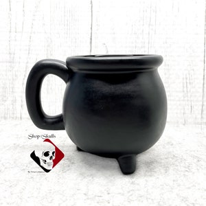 The black cauldron mug measures:
- 4 1/4 inches tall
- 3 1/4 inches in diameter cup only
- Holds 16 oz
- finished with lead free matte black glaze - dishwasher safe
- Made to Order
Shop for more amazing items on my website at www.ShopOfSkulls.com.