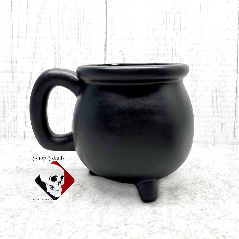 The black cauldron mug measures:
- 4 1/4 inches tall
- 3 1/4 inches in diameter cup only
- Holds 16 oz
- finished with lead free matte black glaze - dishwasher safe
- Made to Order
Shop for more amazing items on my website at www.ShopOfSkulls.com.
