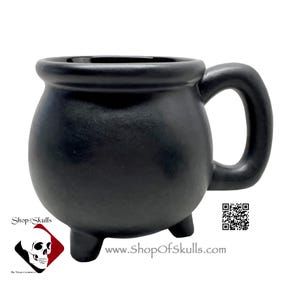 May include: Black ceramic cauldron mug with a handle and three short legs. The mug has a website address printed on the bottom: www.ShopOfSkulls.com